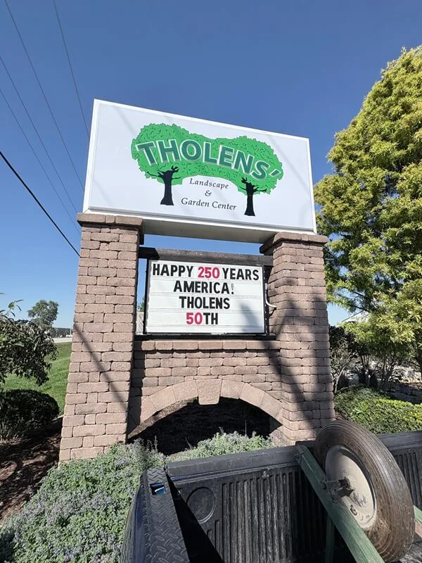 An image of the exterior monument sign for Tholens', which includes a lit up marquee.